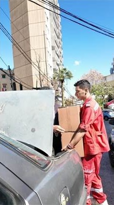 Description: A person in a red uniform holding a box  AI-generated content may be incorrect.