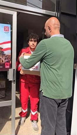 Description: A person holding a box  AI-generated content may be incorrect.